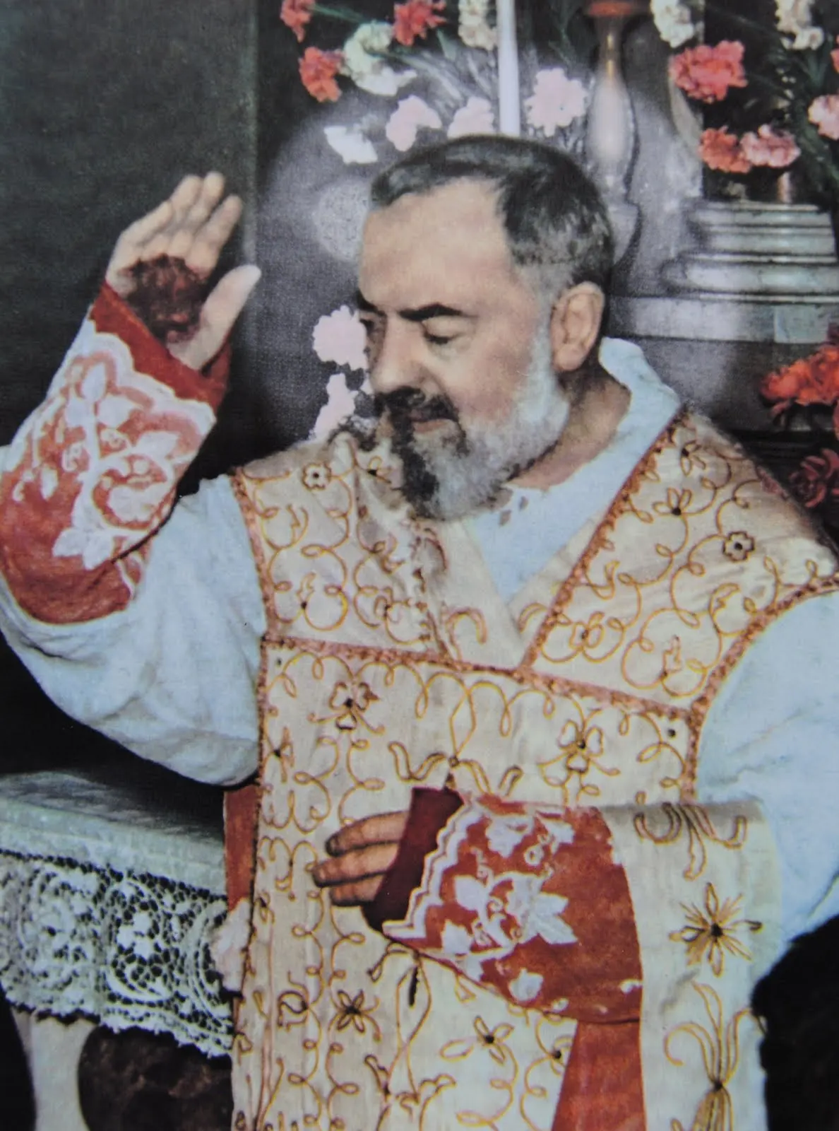 Padre Pio raising his hands, the wounds of the stigmata visible
