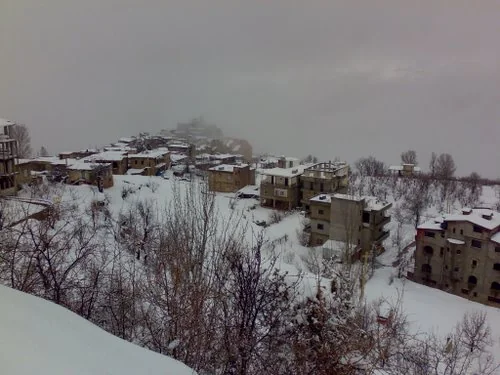 Snow lying on the stone houses and roofs of Bekaa Kafra on a winter day